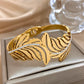 Featherelle – Elegant Gold-Plated Feather & Rhinestone Cuff Bracelet